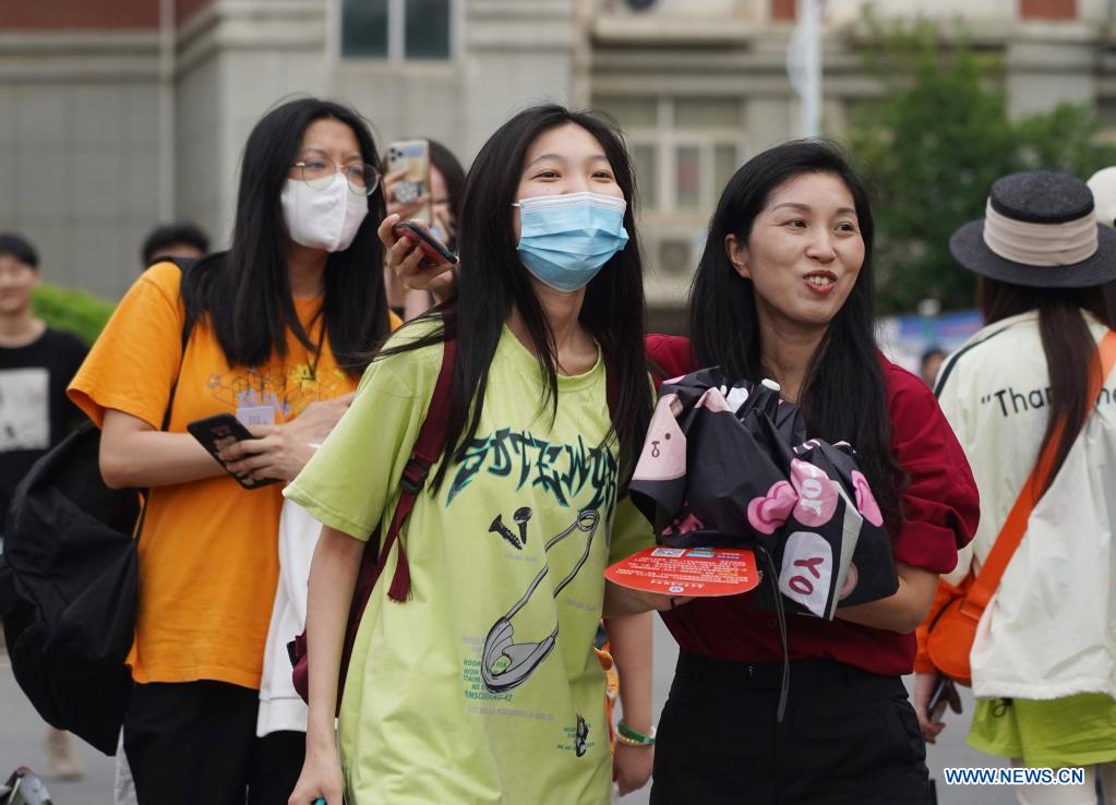  An examinee is greeted by her parent (R, front) while walking out of an exam site at a high school in Nanchang, the capital city of east China's Jiangxi Province, June 8, 2021. China's annual college entrance exam concluded on Tuesday in some parts of the country. Considered the world's most grueling test, the exam, better known as the Gaokao, saw a record 10.78 million candidates signing up this year. (Xinhua/Wan Xiang)