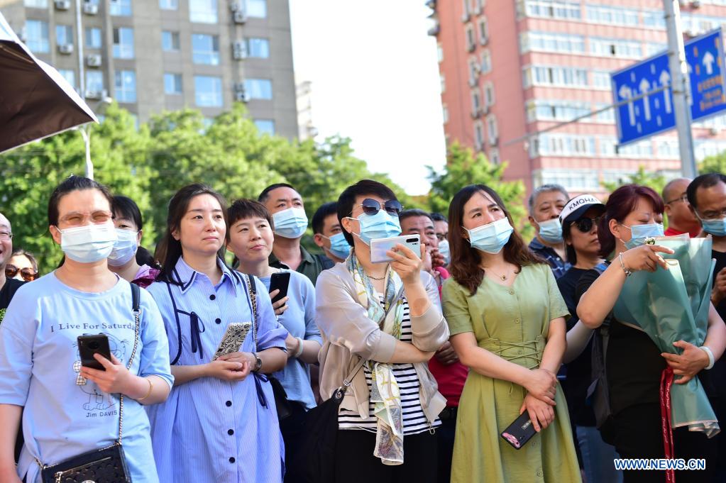 Parents wait outside an exam site at a middle school in Beijing, capital of China, June 10, 2021. The annual college entrance exam concluded Thursday in Beijing. (Xinhua/Peng Ziyang)