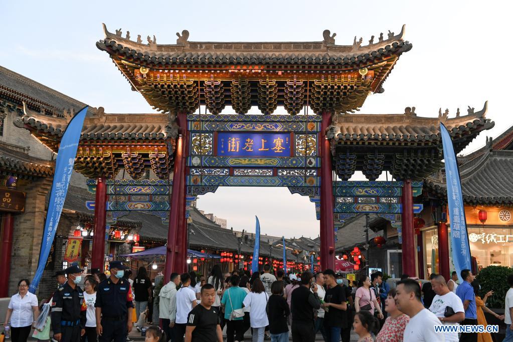 Tourists visit an old street in Hohhot, north China's Inner Mongolia Autonomous Region, June 10, 2021. Various activities such as appreciating traditional music and tasting local food are held here to promote tourism. (Xinhua/Bei He)