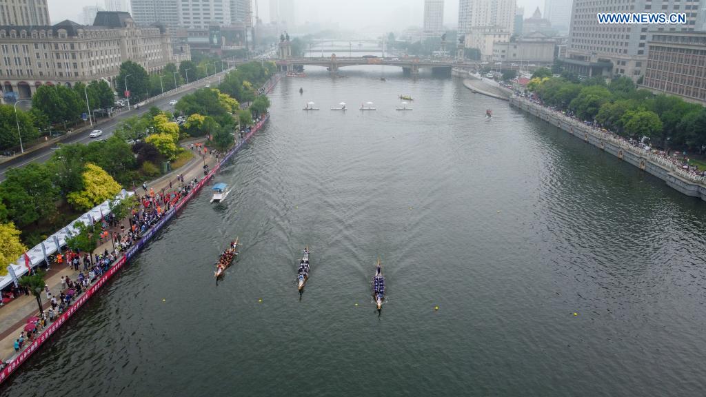 Aerial photo taken on June 14, 2021 shows people participating in a dragon boat race to celebrate the Dragon Boat Festival in Tianjin, north China. China celebrated the Dragon Boat Festival on Monday to commemorate Qu Yuan, a patriotic poet from the Warring States Period (475-221 BC). (Photo by Sun Fanyue/Xinhua)