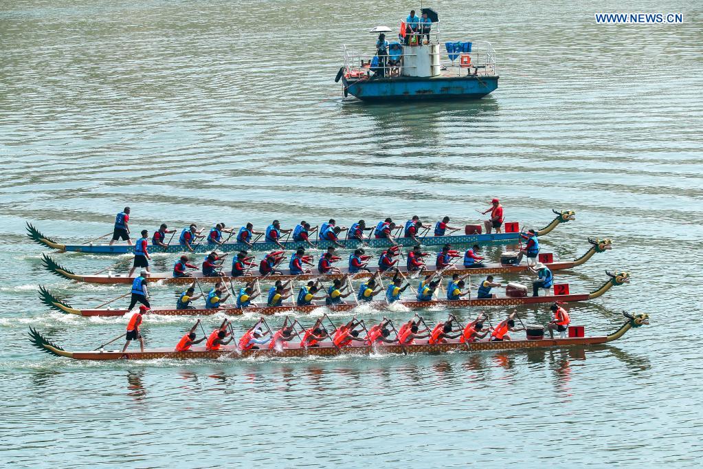 People participate in a dragon boat race to celebrate the Dragon Boat Festival in Zigui County, central China's Hubei Province, June 14, 2021. China celebrated the Dragon Boat Festival on Monday to commemorate Qu Yuan, a patriotic poet from the Warring States Period (475-221 BC) believed to have been born in Zigui County. (Photo by Wang Gang/Xinhua)