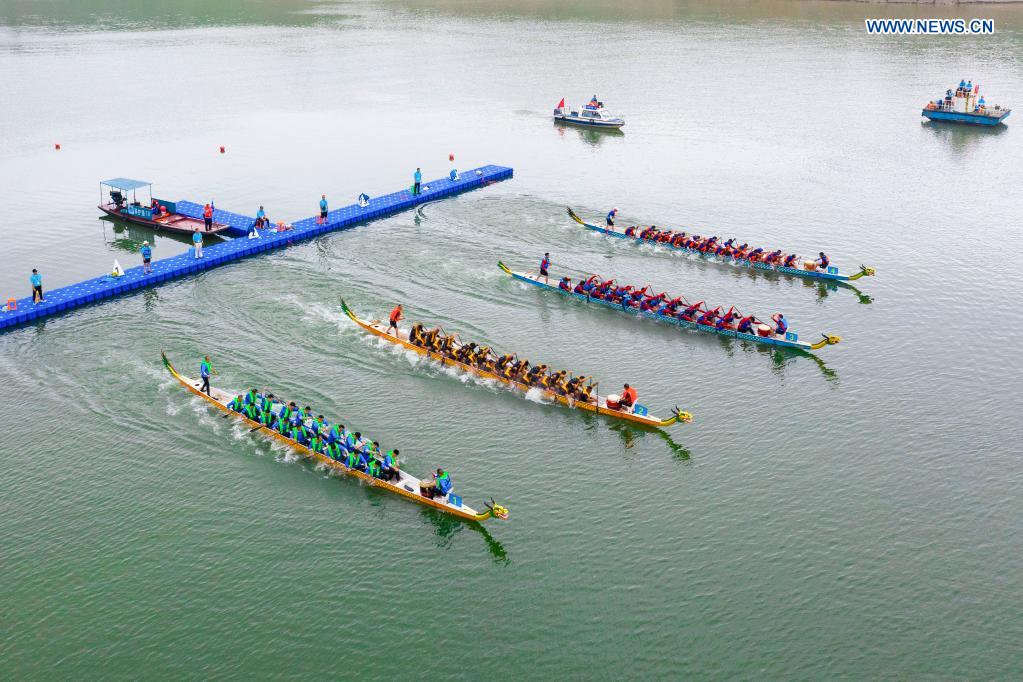 People participate in a dragon boat race to celebrate the Dragon Boat Festival in Zigui County, central China's Hubei Province, June 14, 2021. China celebrated the Dragon Boat Festival on Monday to commemorate Qu Yuan, a patriotic poet from the Warring States Period (475-221 BC) believed to have been born in Zigui County. (Photo by Nie Shuang/Xinhua)