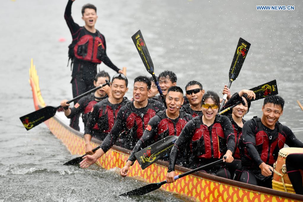 Participants celebrate after a dragon boat race to celebrate the Dragon Boat Festival in Tianjin, north China, June 14, 2021. China celebrated the Dragon Boat Festival on Monday to commemorate Qu Yuan, a patriotic poet from the Warring States Period (475-221 BC). (Xinhua/Zhao Zishuo)