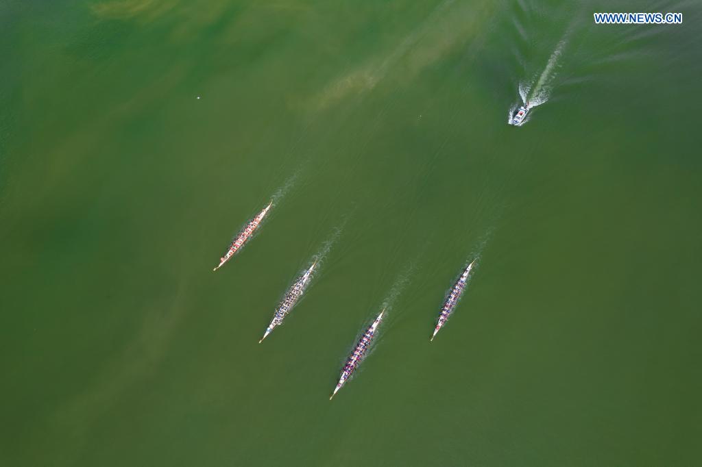 Aerial photo taken on June 14, 2021 shows people participating in a dragon boat race to celebrate the Dragon Boat Festival in Zigui County, central China's Hubei Province. China celebrated the Dragon Boat Festival on Monday to commemorate Qu Yuan, a patriotic poet from the Warring States Period (475-221 BC) believed to have been born in Zigui County. (Photo by Mei Xuefei/Xinhua)