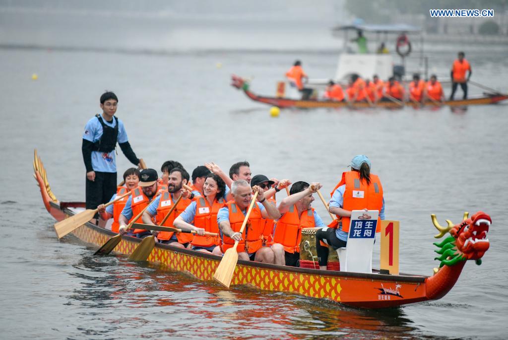 Participants wave to the audience after a dragon boat race to celebrate the Dragon Boat Festival in Tianjin, north China, June 14, 2021. China celebrated the Dragon Boat Festival on Monday to commemorate Qu Yuan, a patriotic poet from the Warring States Period (475-221 BC). (Photo by Sun Fanyue/Xinhua)