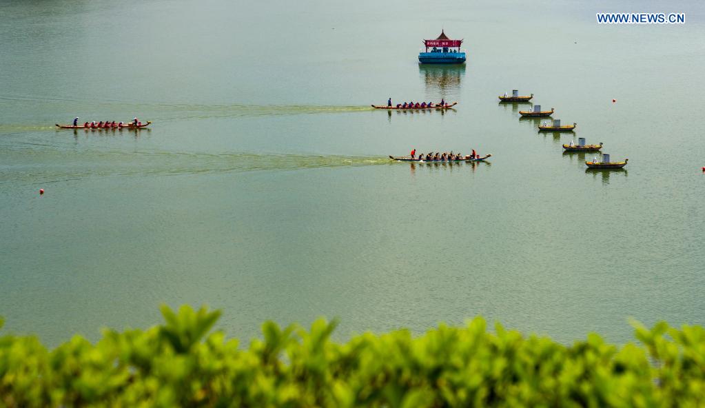 People participate in a dragon boat race to celebrate the Dragon Boat Festival in Zigui County, central China's Hubei Province, June 14, 2021. China celebrated the Dragon Boat Festival on Monday to commemorate Qu Yuan, a patriotic poet from the Warring States Period (475-221 BC) believed to have been born in Zigui County. (Photo by Xiang Hongmei/Xinhua)