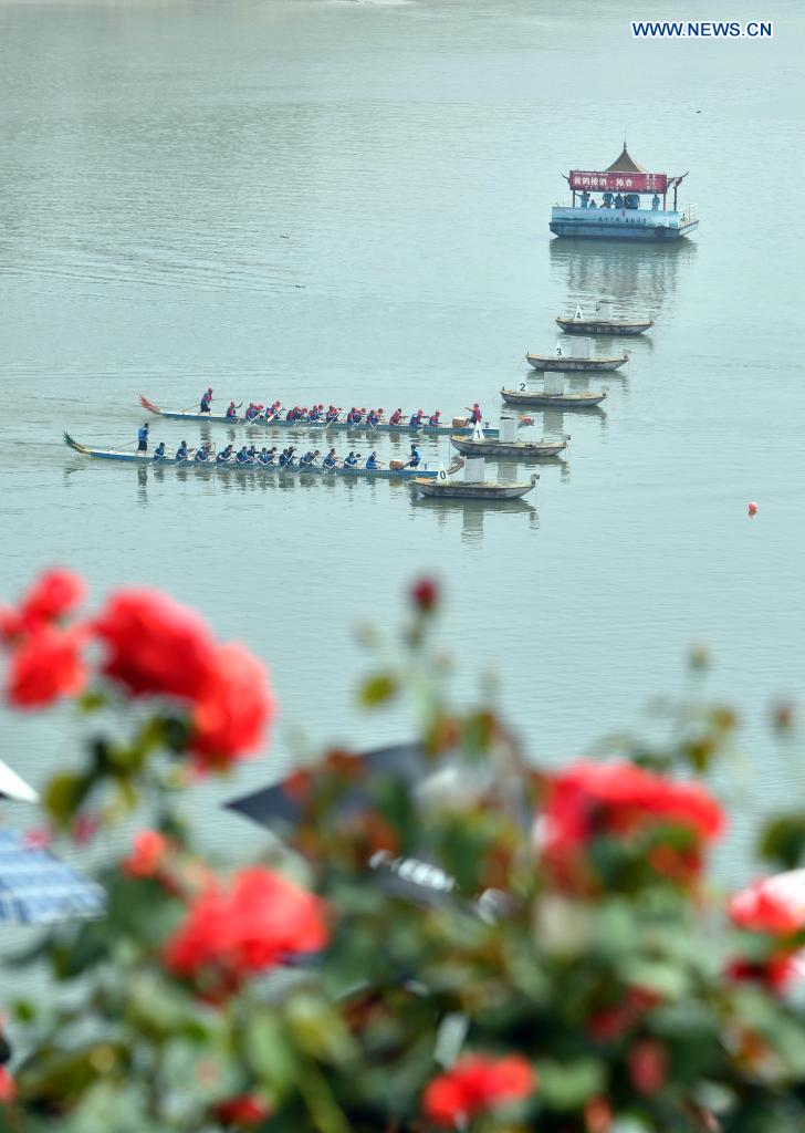 People participate in a dragon boat race to celebrate the Dragon Boat Festival in Zigui County, central China's Hubei Province, June 14, 2021. China celebrated the Dragon Boat Festival on Monday to commemorate Qu Yuan, a patriotic poet from the Warring States Period (475-221 BC) believed to have been born in Zigui County. (Photo by Wang Huifu/Xinhua)