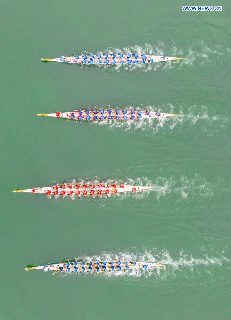 Aerial photo taken on June 14, 2021 shows people participating in a dragon boat race to celebrate the Dragon Boat Festival in Zigui County, central China's Hubei Province. China celebrated the Dragon Boat Festival on Monday to commemorate Qu Yuan, a patriotic poet from the Warring States Period (475-221 BC) believed to have been born in Zigui County. (Photo by Nie Shuang/Xinhua)