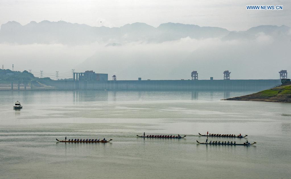 People participate in a dragon boat race to celebrate the Dragon Boat Festival in Zigui County, central China's Hubei Province, June 14, 2021. China celebrated the Dragon Boat Festival on Monday to commemorate Qu Yuan, a patriotic poet from the Warring States Period (475-221 BC) believed to have been born in Zigui County. (Photo by Xiang Hongmei/Xinhua)