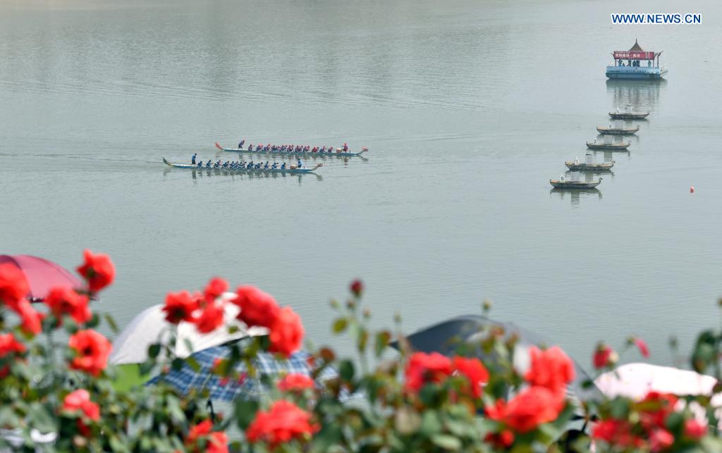 People participate in a dragon boat race to celebrate the Dragon Boat Festival in Zigui County, central China's Hubei Province, June 14, 2021. China celebrated the Dragon Boat Festival on Monday to commemorate Qu Yuan, a patriotic poet from the Warring States Period (475-221 BC) believed to have been born in Zigui County. (Photo by Wang Huifu/Xinhua)