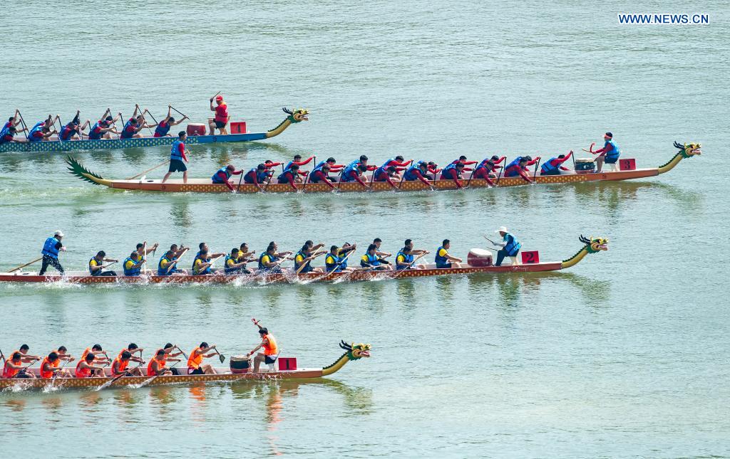 People participate in a dragon boat race to celebrate the Dragon Boat Festival in Zigui County, central China's Hubei Province, June 14, 2021. China celebrated the Dragon Boat Festival on Monday to commemorate Qu Yuan, a patriotic poet from the Warring States Period (475-221 BC) believed to have been born in Zigui County. (Photo by Zheng Jiayu/Xinhua)