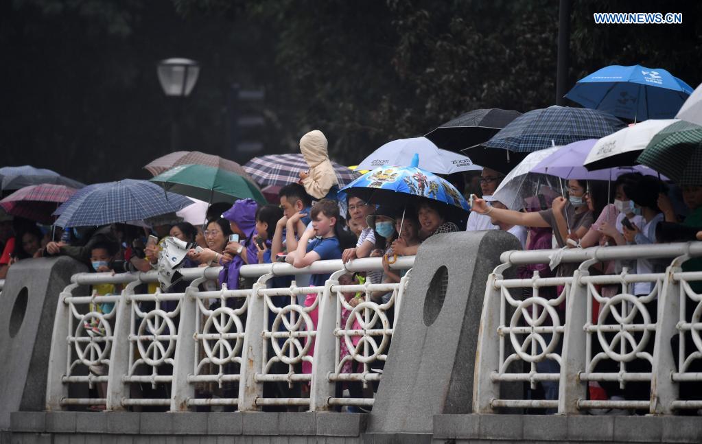 People watch a dragon boat race to celebrate the Dragon Boat Festival in Tianjin, north China, June 14, 2021. China celebrated the Dragon Boat Festival on Monday to commemorate Qu Yuan, a patriotic poet from the Warring States Period (475-221 BC). (Xinhua/Zhao Zishuo)