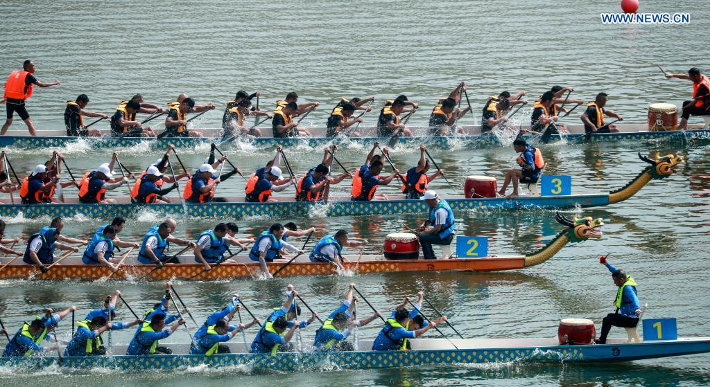 People participate in a dragon boat race to celebrate the Dragon Boat Festival in Zigui County, central China's Hubei Province, June 14, 2021. China celebrated the Dragon Boat Festival on Monday to commemorate Qu Yuan, a patriotic poet from the Warring States Period (475-221 BC) believed to have been born in Zigui County. (Photo by Wang Gang/Xinhua)