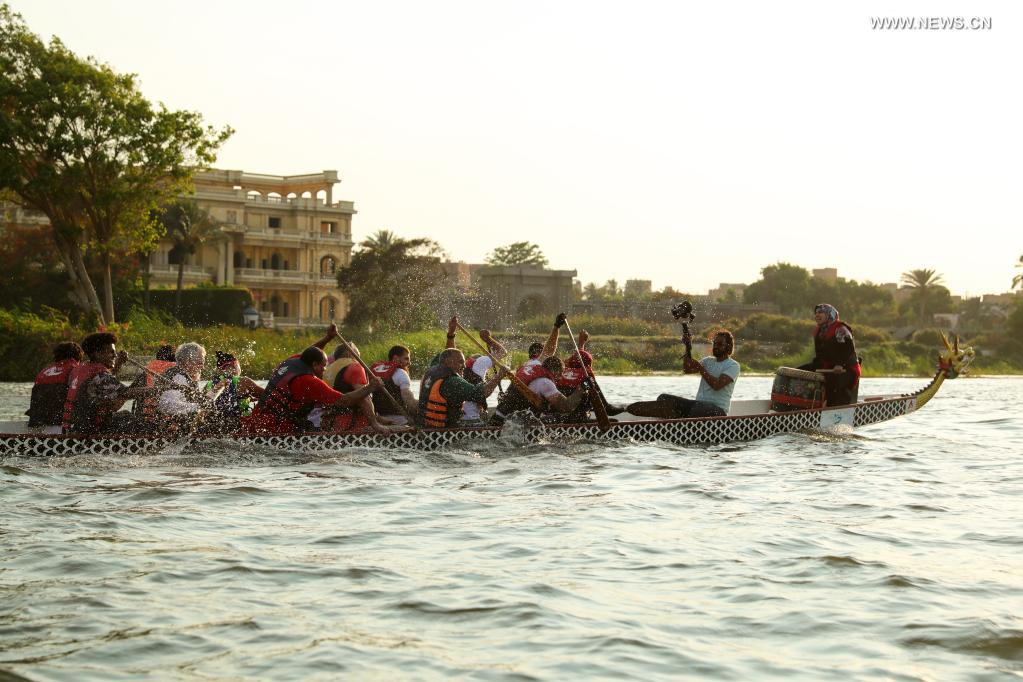 Paddlers from Dragon Boat Egypt Academy compete during a dragon boat race on the Nile in Cairo, Egypt, on June 14, 2021. The dragon boat race was held here on Monday to celebrate the traditional Chinese Dragon Boat Festival. (Xinhua/Sui Xiankai)