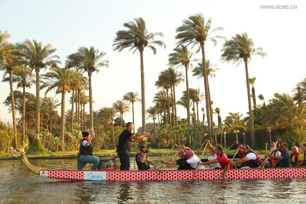 Paddlers from Dragon Boat Egypt Academy compete during a dragon boat race on the Nile in Cairo, Egypt, on June 14, 2021. The dragon boat race was held here on Monday to celebrate the traditional Chinese Dragon Boat Festival. (Xinhua/Sui Xiankai)