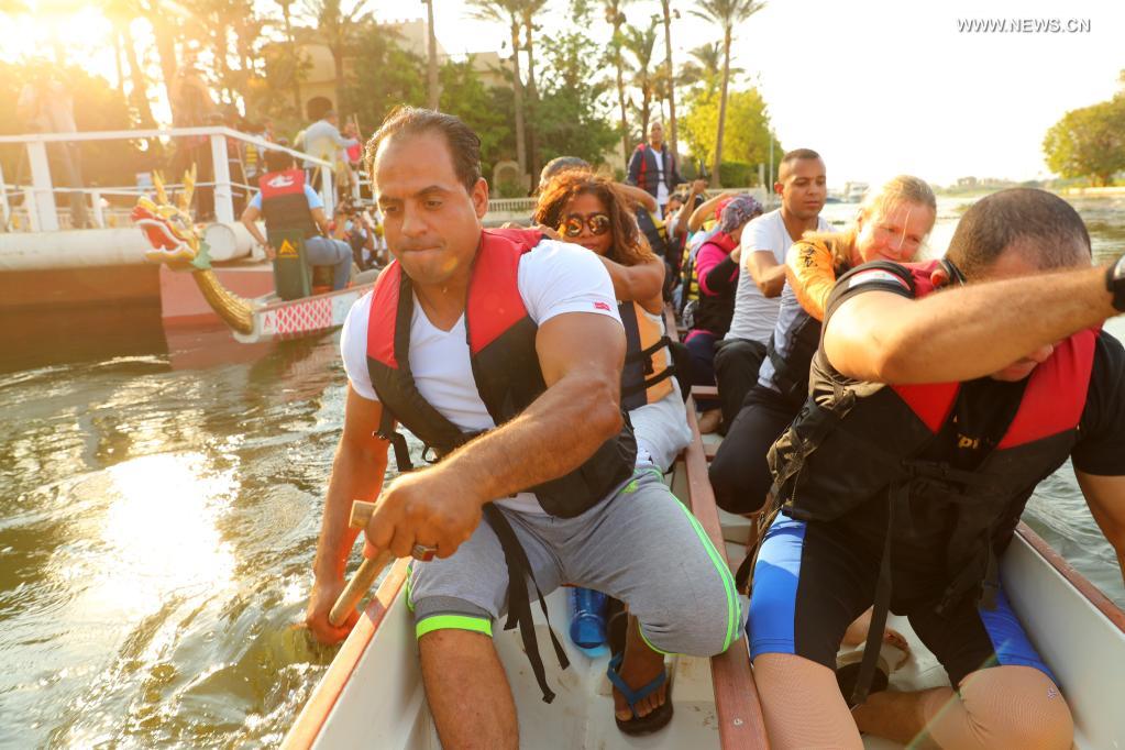 Paddlers from Dragon Boat Egypt Academy row for a dragon boat race on the Nile in Cairo, Egypt, on June 14, 2021. The dragon boat race was held here on Monday to celebrate the traditional Chinese Dragon Boat Festival. (Xinhua/Sui Xiankai)