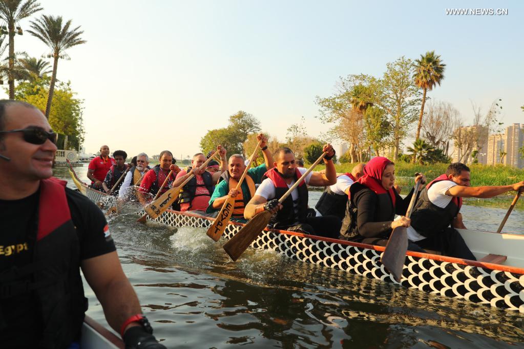 Paddlers from Dragon Boat Egypt Academy row for a dragon boat race on the Nile in Cairo, Egypt, on June 14, 2021. The dragon boat race was held here on Monday to celebrate the traditional Chinese Dragon Boat Festival. (Xinhua/Sui Xiankai)