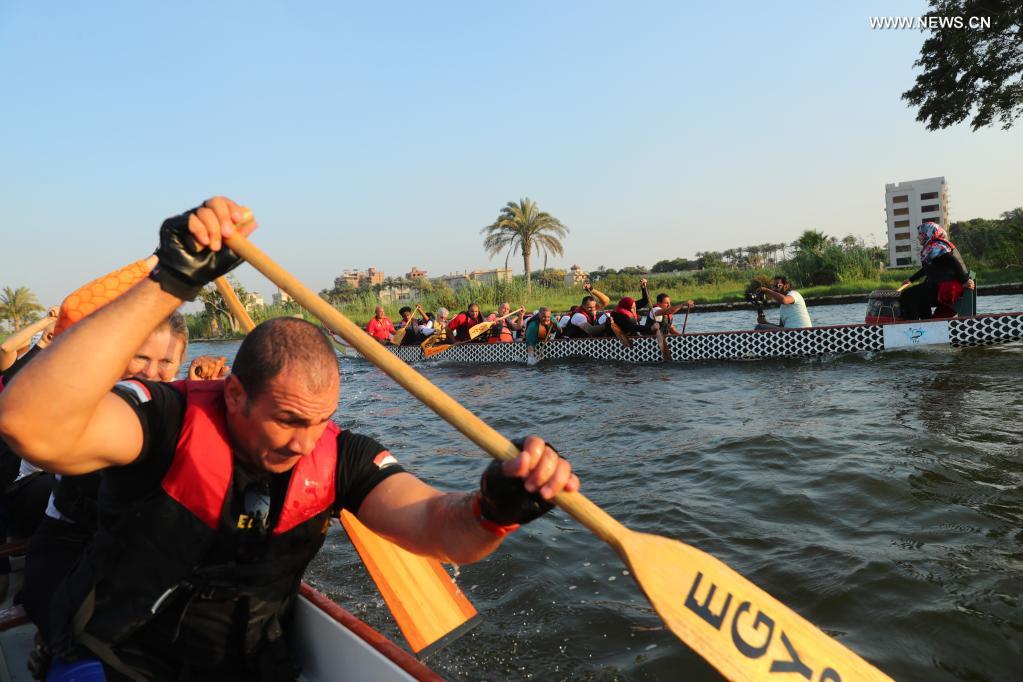 Paddlers from Dragon Boat Egypt Academy compete during a dragon boat race on the Nilein Cairo, Egypt, on June 14, 2021. The dragon boat race was held here on Monday to celebrate the traditional Chinese Dragon Boat Festival. (Xinhua/Sui Xiankai)