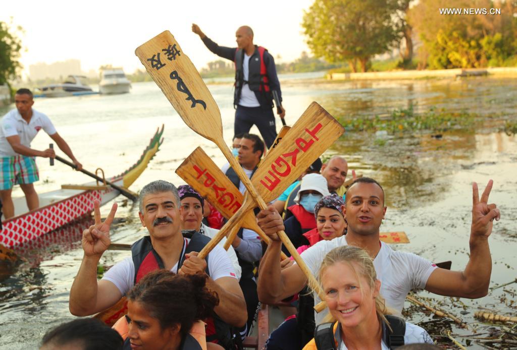 Paddlers from Dragon Boat Egypt Academy celebrate after a dragon boat race on the Nile in Cairo, Egypt, on June 14, 2021. The dragon boat race was held here on Monday to celebrate the traditional Chinese Dragon Boat Festival. (Xinhua/Sui Xiankai)