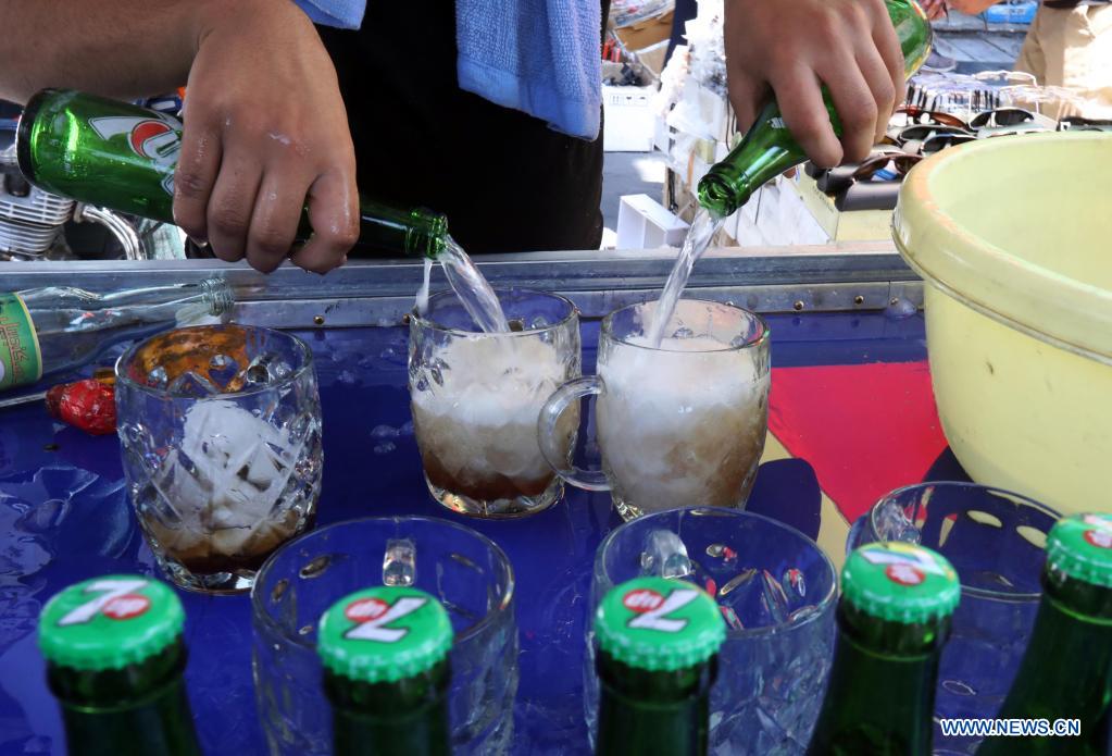 A seller prepares cold drinks in Baghdad, Iraq, on June 29, 2021. Scorching weather started here in June and temperatures rose to about 50 degrees Celsius. (Photo by Omar Khalil/Xinhua)