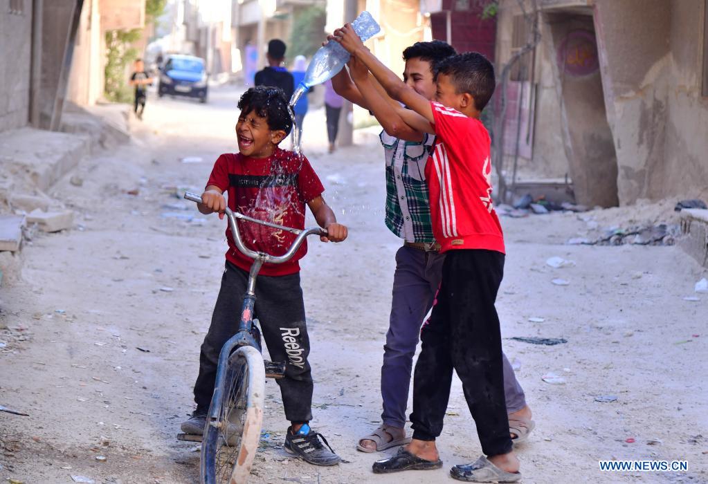 Syrian children cool off with water during hot weather in Damascus, Syria, on June 29, 2021. (Photo by Ammar Safarjalani/Xinhua)