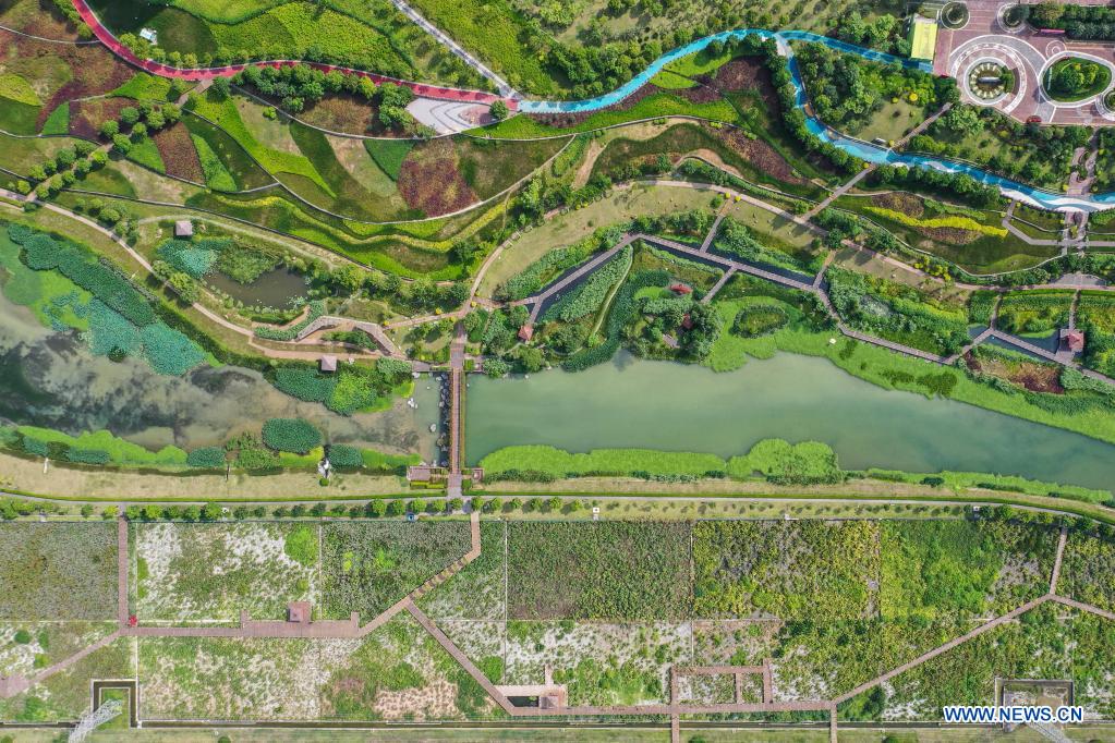 Aerial photo taken on July 11, 2021 shows the Nakao River wetland park in Nanning, south China's Guangxi Zhuang Autonomous Region. Nakao River in Nanning was once a polluted muddy gutter lined with sewage outlets. In 2015, a public-private partnership (PPP) project was rolled out to improve the ecological environment along the river. Pollution control measures including sewage interception and treatment, as well as aquatic ecosystem restoration, have helped turn the river into a wetland park with lucid waters. (Xinhua/Cao Yiming)
