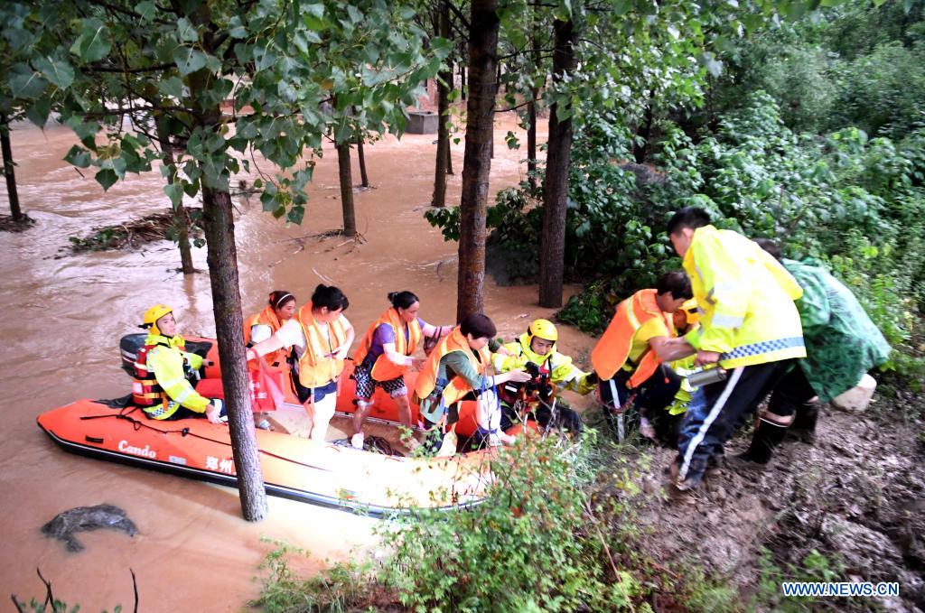 Rescuers transfer stranded villagers in Longtou Village, Dengfeng City of central China's Henan Province, July 20, 2021. Longtou Village was hit by mountain torrents on Tuesday. Rescuers have transferred over 50 villagers to safer places. (Xinhua/Hao Yuan)