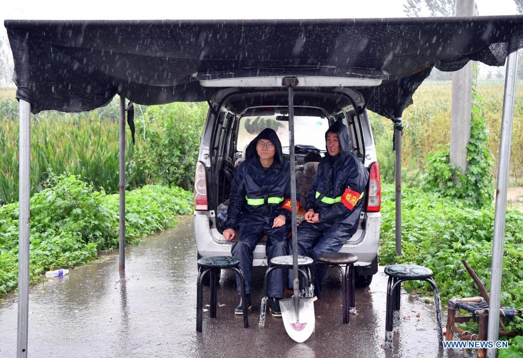 Flood-control workers are seen in Chenzhuang Village, Motou Township, Bo'ai County of Jiaozuo, central China's Henan Province, July 20, 2021. Rivers in Jiaozuo have witnessed rising water level as continuous rainfalls recently hit the city. Local authorities have organized flood-control workers to patrol the city around the clock and eliminate hidden dangers to protect the safety of people's lives and property. (Xinhua/Li Jianan)