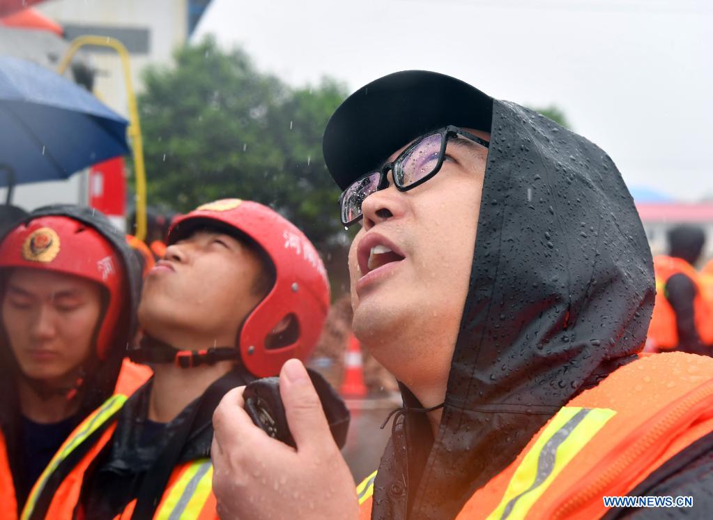 A fire fighter warns villagers of flood danger via a drone in Zhouzhuang Township, Xiuwu County of Jiaozuo, central China's Henan Province, July 20, 2021. Rivers in Jiaozuo have witnessed rising water level as continuous rainfalls recently hit the city. Local authorities have organized flood-control workers to patrol the city around the clock and eliminate hidden dangers to protect the safety of people's lives and property. (Xinhua/Li Jianan)