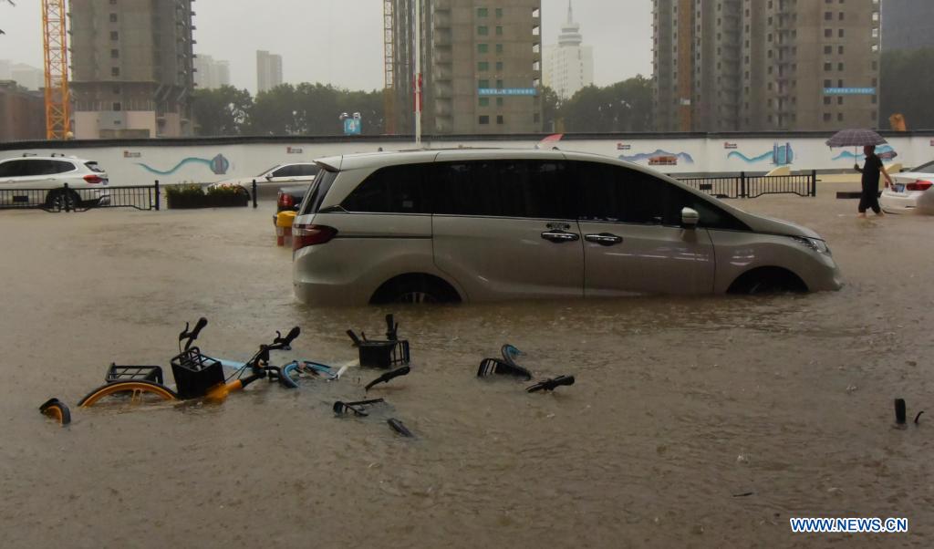 A car is inundated by rainwater in Zhengzhou, capital of central China's Henan Province, July 20, 2021. More than 144,660 residents have been affected by torrential rains in central China's Henan Province since July 16, and 10,152 have been relocated to safe places, the provincial flood control and drought relief headquarters said Tuesday. A total of 16 large and medium-sized reservoirs have seen water levels rise above the alert level after torrential rains battered most parts of the province on Monday and Tuesday. (Xinhua/Zhu Xiang)