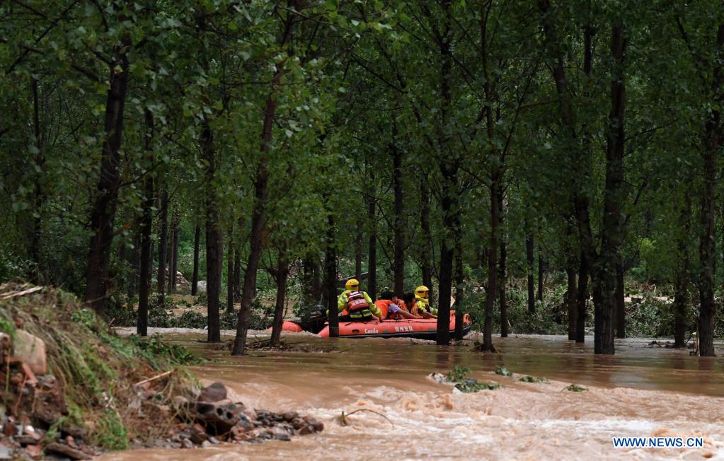 Rescuers transfer stranded villagers in Longtou Village, Dengfeng City of central China's Henan Province, July 20, 2021. Longtou Village was hit by mountain torrents on Tuesday. Rescuers have transferred over 50 villagers to safer places. (Xinhua/Hao Yuan)