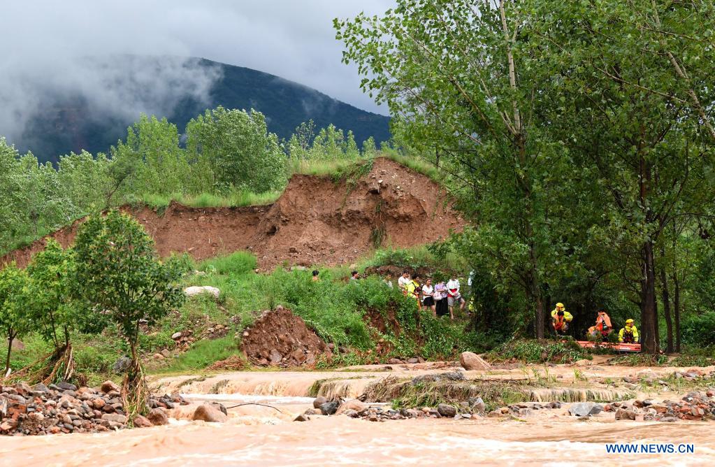Rescuers transfer stranded villagers in Longtou Village, Dengfeng City of central China's Henan Province, July 20, 2021. Longtou Village was hit by mountain torrents on Tuesday. Rescuers have transferred over 50 villagers to safer places. (Xinhua/Hao Yuan)