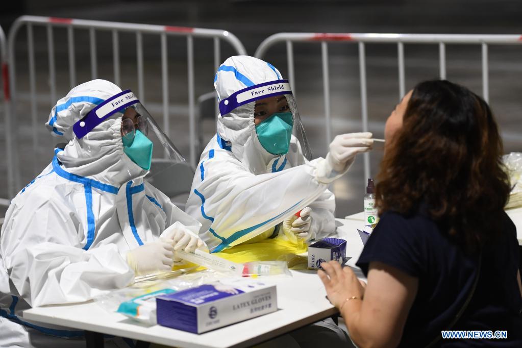 A medical worker takes a swab sample from a woman for COVID-19 test at a testing site in Nanjing, east China's Jiangsu Province, July 21, 2021. Nanjing, which has a population of more than 9.3 million, carried out citywide nucleic acid testing starting on Wednesday. (Xinhua/Ji Chunpeng)