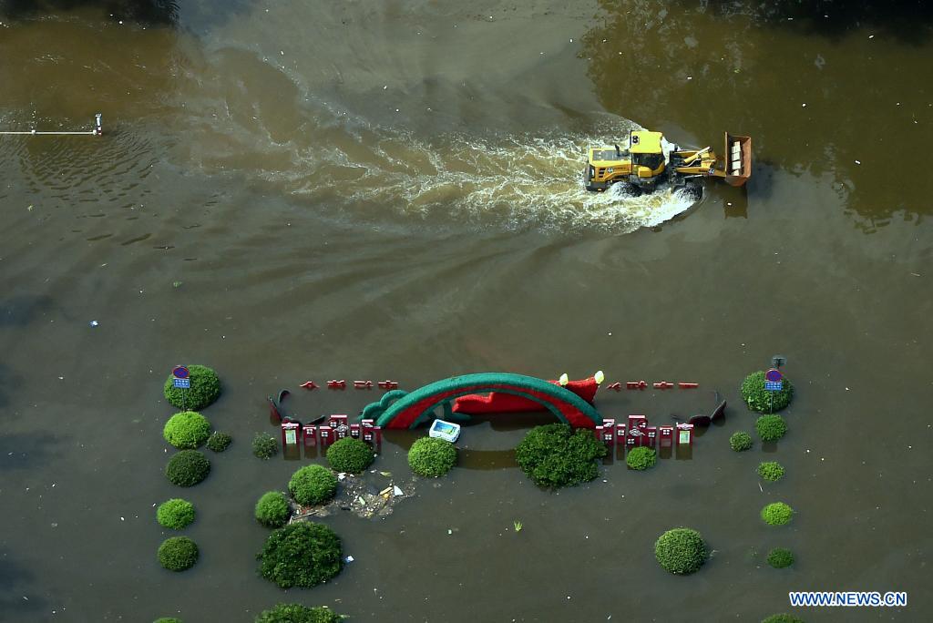 Supplies are Transfered on a shovel loader in flood-hit Weihui City, central China's Henan Province, July 24, 2021. (Xinhua/Li An)