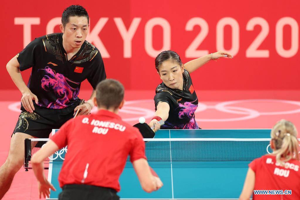 Xu Xin (L, top)/Liu Shiwen (R, top) of China compete during table tennis mixed doubles quarterfinal against Ovidiu Ionescu/Bernadette Szocs of Romania at the Tokyo 2020 Olympic Games in Tokyo, Japan, July 25, 2021. (Xinhua/Zheng Huansong)