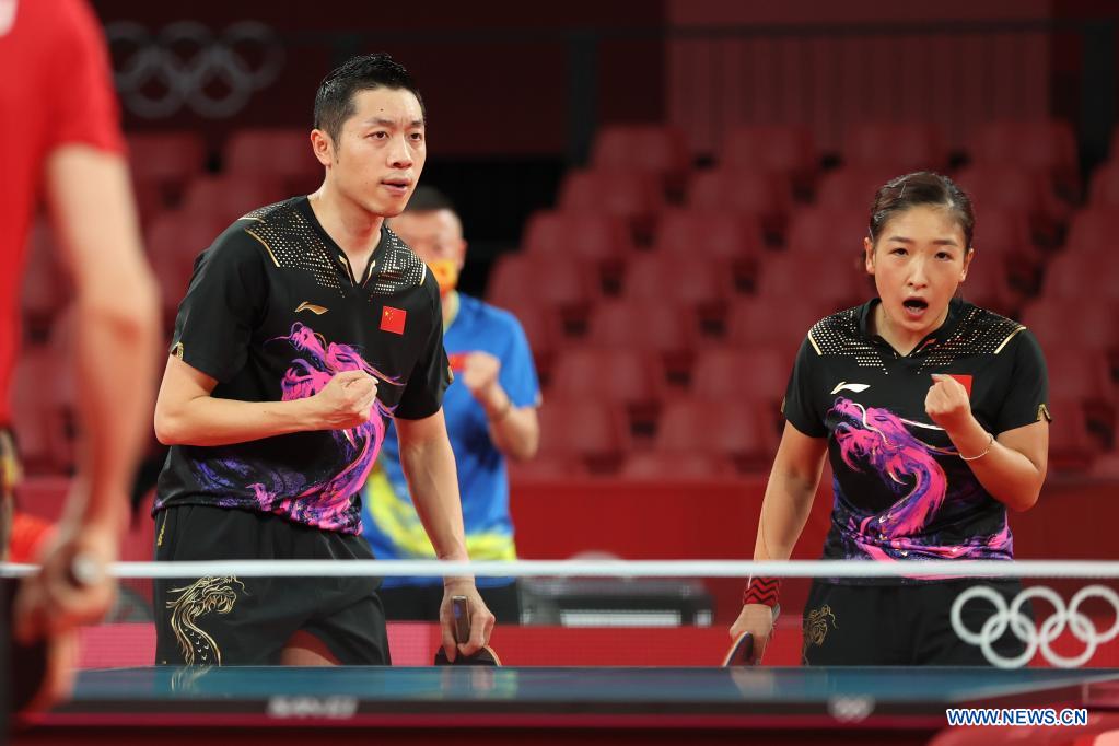 Xu Xin (L)/Liu Shiwen of China celebrate during table tennis mixed doubles quarterfinal against Ovidiu Ionescu/Bernadette Szocs of Romania at the Tokyo 2020 Olympic Games in Tokyo, Japan, July 25, 2021. (Xinhua/Zheng Huansong)