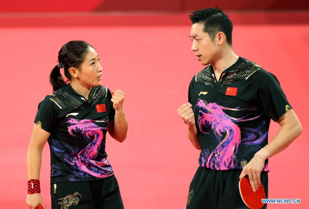 Xu Xin (R)/Liu Shiwen of China celebrate during table tennis mixed doubles quarterfinal against Ovidiu Ionescu/Bernadette Szocs of Romania at the Tokyo 2020 Olympic Games in Tokyo, Japan, July 25, 2021. (Xinhua/Zheng Huansong)