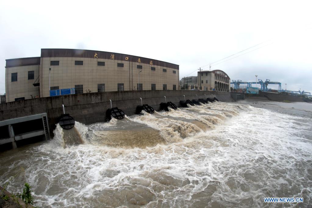 A pump station starts emergency discharging to prevent flooding in Jintang Island of Zhoushan, east China's Zhejiang Province, July 25, 2021. China's national observatory on Sunday continued its orange alert for Typhoon In-Fa, which made landfall in Zhejiang at around Sunday noon. (Photo by Yao Feng/Xinhua)