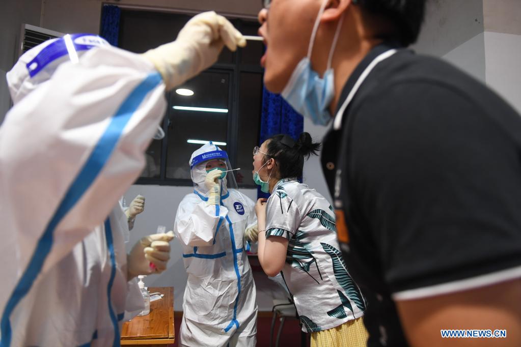 A nurse takes a swab sample from a resident for COVID-19 test at a testing site in Jiangning District of Nanjing, capital of east China's Jiangsu Province, July 25, 2021. Nanjing, a mega-city with a population of more than 9.3 million, has launched a second round of all-inclusive nucleic acid testing and urged residents not to leave the city unless necessary. (Xinhua/Ji Chunpeng)