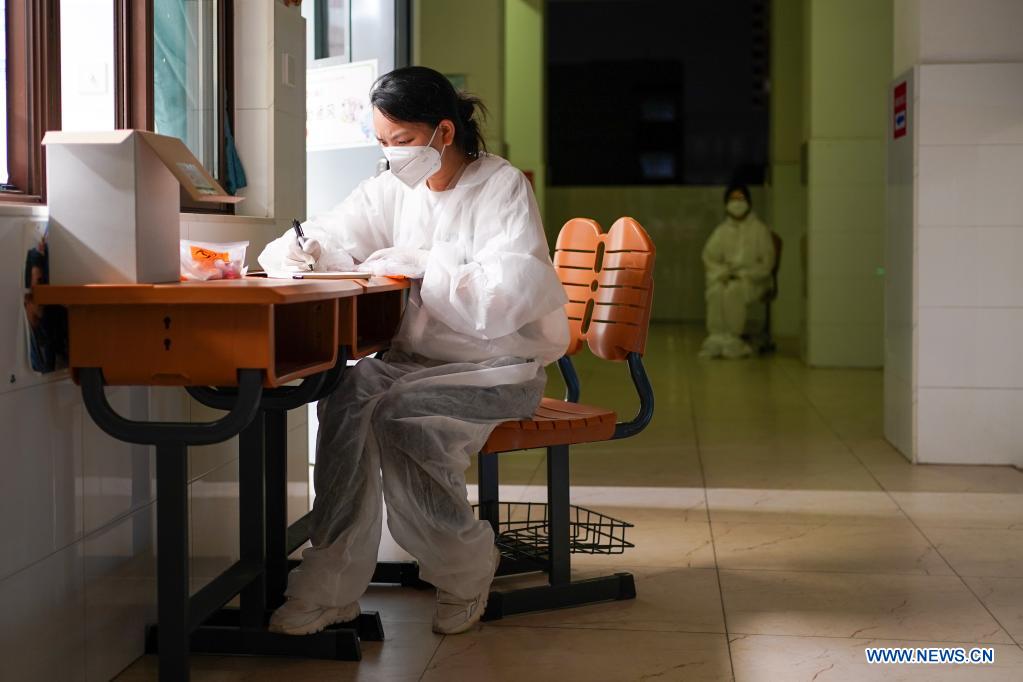 A volunteer rechecks registration information at a COVID-19 testing site in Jiangning District of Nanjing, capital of east China's Jiangsu Province, July 24, 2021. Nanjing, a mega-city with a population of more than 9.3 million, has launched a second round of all-inclusive nucleic acid testing and urged residents not to leave the city unless necessary. (Xinhua/Li Bo)