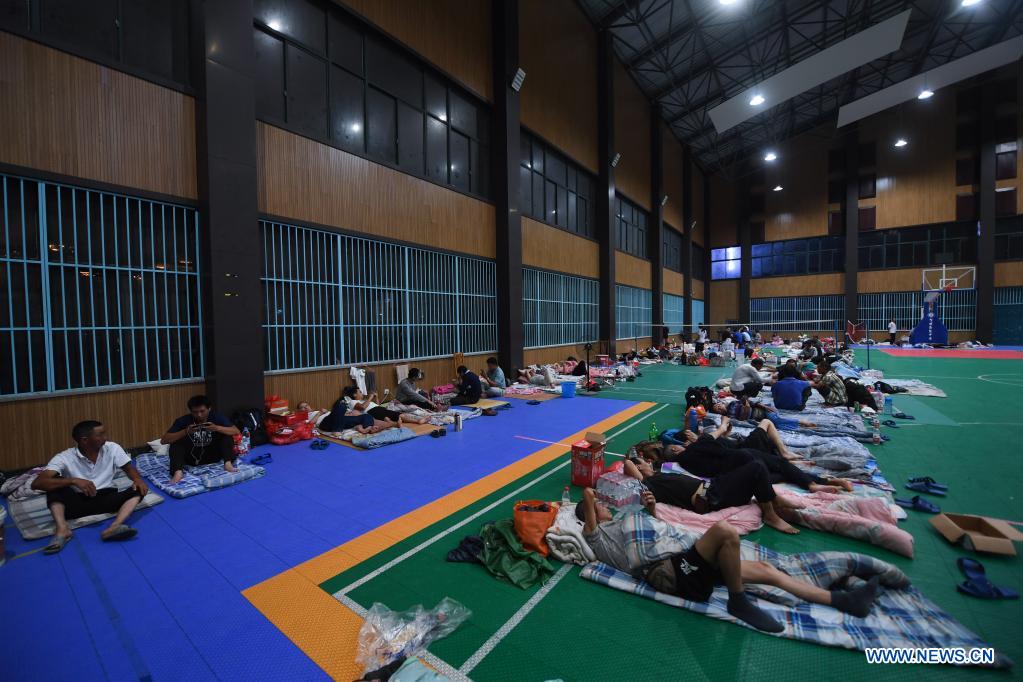 Workers relocated from surrounding construction sites rest at a shelter in Pinghu, Jiaxing, east China's Zhejiang Province, July 25, 2021. China's national observatory on Sunday continued its orange alert for Typhoon In-Fa, which made landfall in Zhejiang at around Sunday noon. Moving northwestward at about 10 km per hour, In-Fa will make another landfall in coastal areas from Pinghu in Zhejiang Province to Pudong in Shanghai, according to the National Meteorological Center. (Xinhua/Xu Yu)