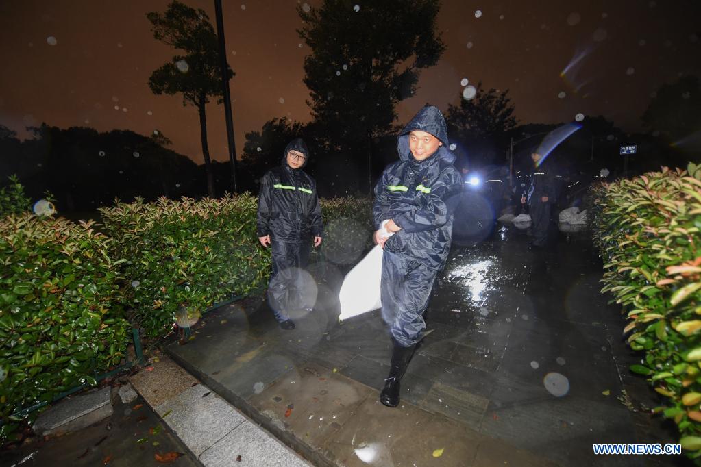 Staff pile sandbags to prevent flood at a park in Pinghu, Jiaxing, east China's Zhejiang Province, July 25, 2021. China's national observatory on Sunday continued its orange alert for Typhoon In-Fa, which made landfall in Zhejiang at around Sunday noon. Moving northwestward at about 10 km per hour, In-Fa will make another landfall in coastal areas from Pinghu in Zhejiang Province to Pudong in Shanghai, according to the National Meteorological Center. (Xinhua/Xu Yu)