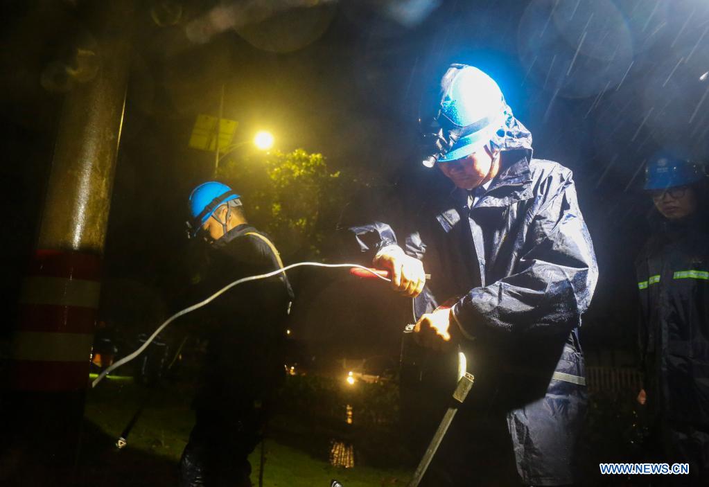 Workers repair electricity devices in Zhoushan, east China's Zhejiang Province, July 24, 2021. China's national observatory on Sunday continued its orange alert for Typhoon In-Fa, which made landfall in Zhejiang at around Sunday noon. (Photo by Zhang Lei/Xinhua)