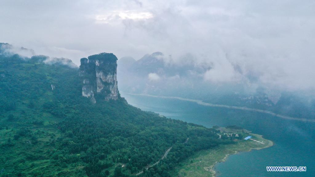Aerial photo taken on July 24, 2021 shows an early morning view of Huawu Village in Xinren Miao Township, Qianxi City, southwest China's Guizhou Province. Huawu Village, although boasting unique ethnic Miao culture and splendid mountain views with vast water bodies, once had a poverty headcount ratio as high as 63.6 percent. Taking advantage of the rich cultural and natural heritage, the local government initiated a scenic area project as a targeted measure to shake off poverty to boost tourism by constructing a 