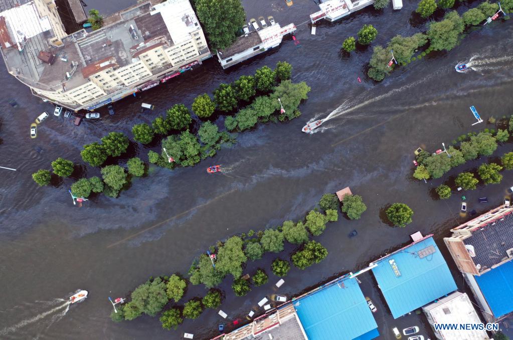 Aerial photo taken on July 26, 2021 shows rescue boats operating on waterlogged streets in downtown Weihui, Xinxiang City of central China's Henan Province. Weihui is suffering from serious flooding caused by heavy downpour in the past few days. Rescue work is still in progress there. (Xinhua/Li Jianan)