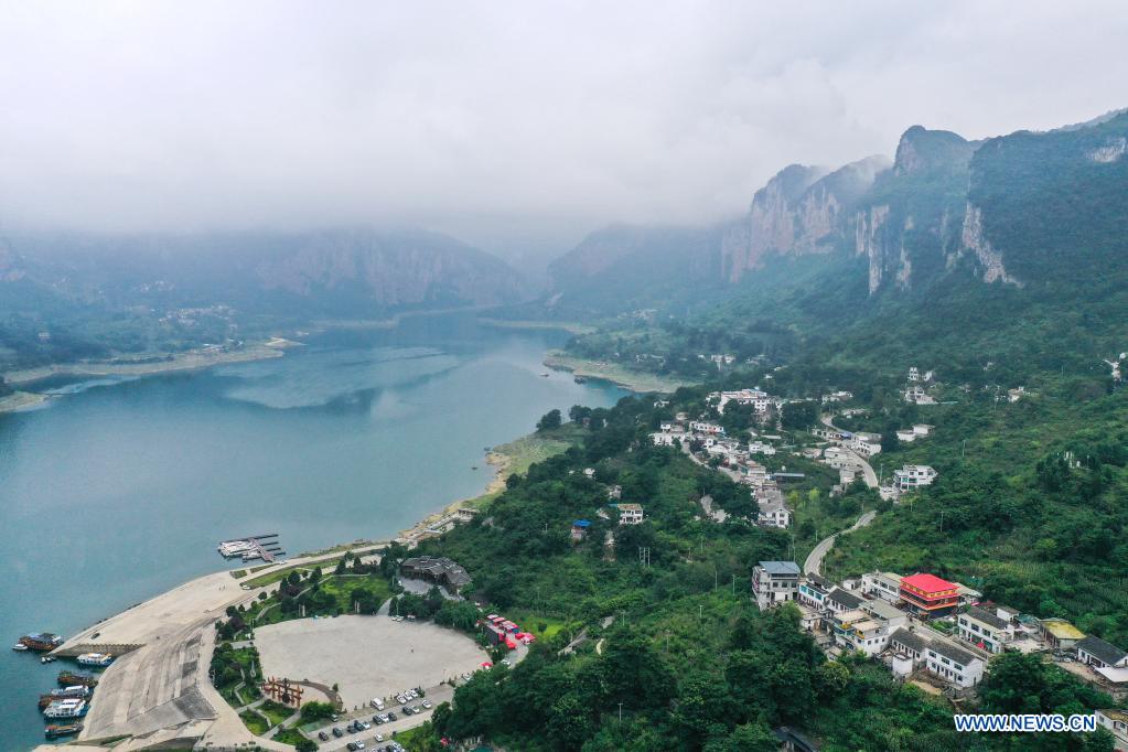 Aerial photo taken on July 24, 2021 shows a view of Huawu Village in Xinren Miao Township, Qianxi City, southwest China's Guizhou Province. Huawu Village, although boasting unique ethnic Miao culture and splendid mountain views with vast water bodies, once had a poverty headcount ratio as high as 63.6 percent. Taking advantage of the rich cultural and natural heritage, the local government initiated a scenic area project as a targeted measure to shake off poverty to boost tourism by constructing a 