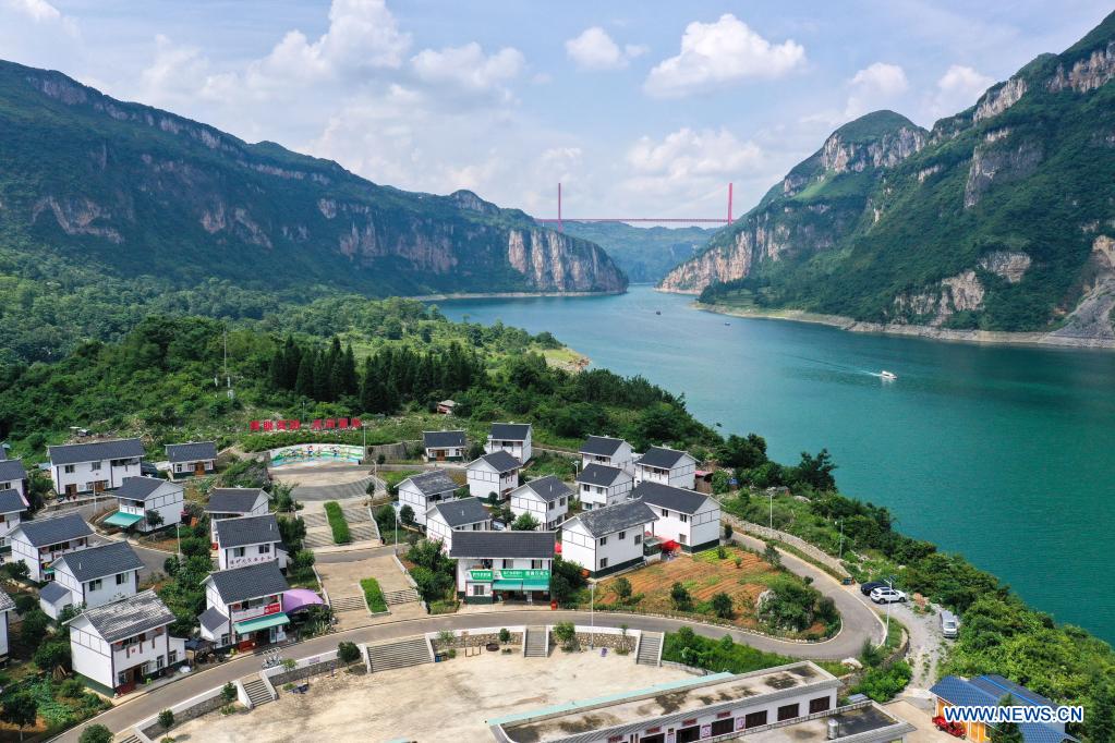 Aerial photo taken on July 24, 2021 shows a view of a relocation site for poverty alleviation at Huawu Village in Xinren Miao Township, Qianxi City, southwest China's Guizhou Province. Huawu Village, although boasting unique ethnic Miao culture and splendid mountain views with vast water bodies, once had a poverty headcount ratio as high as 63.6 percent. Taking advantage of the rich cultural and natural heritage, the local government initiated a scenic area project as a targeted measure to shake off poverty to boost tourism by constructing a 