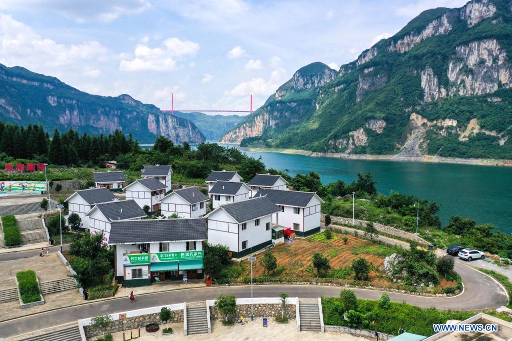 Aerial photo taken on July 24, 2021 shows a view of a relocation site for poverty alleviation at Huawu Village in Xinren Miao Township, Qianxi City, southwest China's Guizhou Province. Huawu Village, although boasting unique ethnic Miao culture and splendid mountain views with vast water bodies, once had a poverty headcount ratio as high as 63.6 percent. Taking advantage of the rich cultural and natural heritage, the local government initiated a scenic area project as a targeted measure to shake off poverty to boost tourism by constructing a 