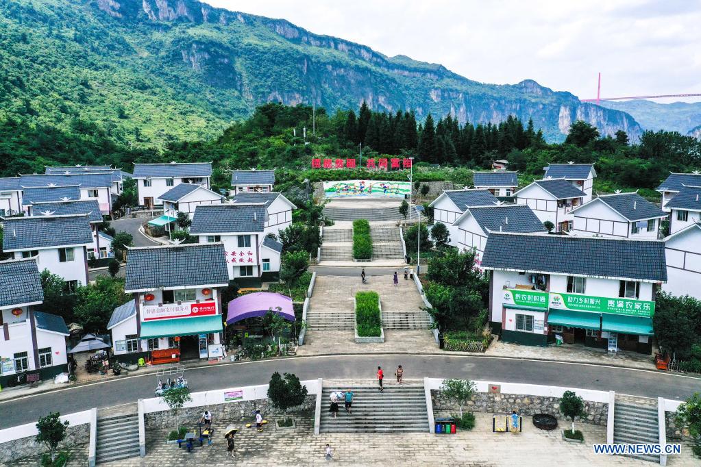 Aerial photo taken on July 24, 2021 shows a view of a relocation site for poverty alleviation at Huawu Village in Xinren Miao Township, Qianxi City, southwest China's Guizhou Province. Huawu Village, although boasting unique ethnic Miao culture and splendid mountain views with vast water bodies, once had a poverty headcount ratio as high as 63.6 percent. Taking advantage of the rich cultural and natural heritage, the local government initiated a scenic area project as a targeted measure to shake off poverty to boost tourism by constructing a 