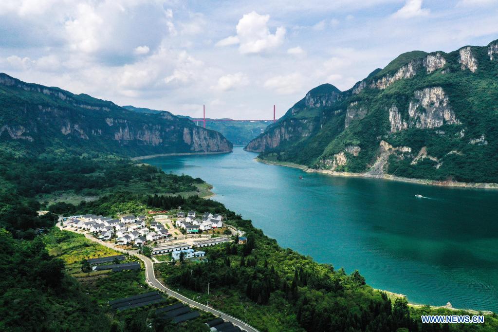 Aerial photo taken on July 24, 2021 shows a view of a relocation site for poverty alleviation at Huawu Village in Xinren Miao Township, Qianxi City, southwest China's Guizhou Province. Huawu Village, although boasting unique ethnic Miao culture and splendid mountain views with vast water bodies, once had a poverty headcount ratio as high as 63.6 percent. Taking advantage of the rich cultural and natural heritage, the local government initiated a scenic area project as a targeted measure to shake off poverty to boost tourism by constructing a 